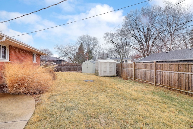 view of yard featuring an outbuilding, a fenced backyard, and a shed