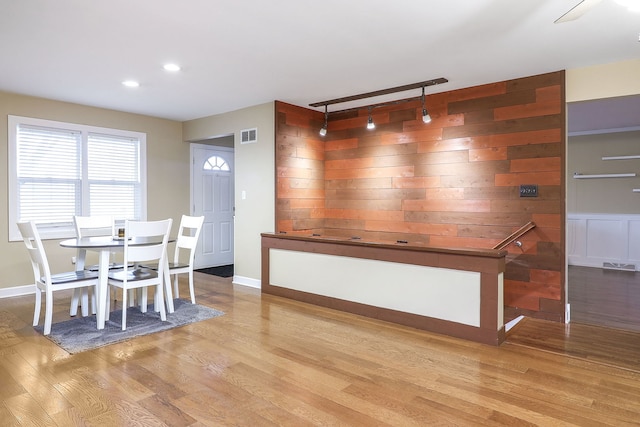 dining area featuring wood finished floors, visible vents, and baseboards