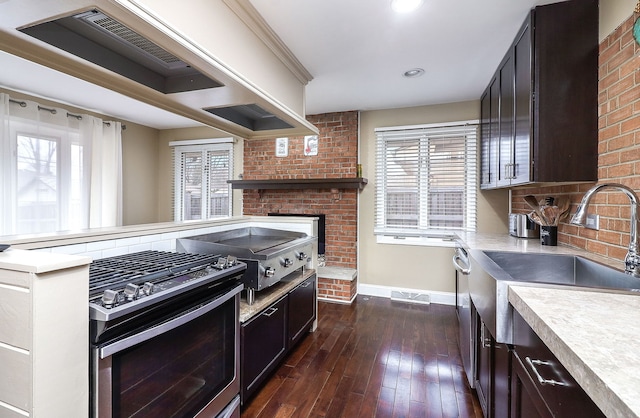 kitchen featuring appliances with stainless steel finishes, light countertops, and a healthy amount of sunlight