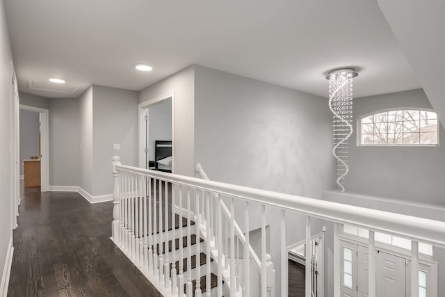 hall featuring dark wood-style flooring, recessed lighting, an upstairs landing, and baseboards