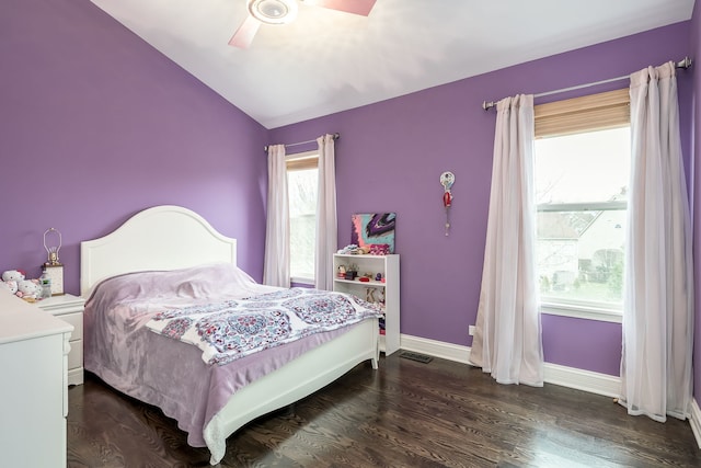 bedroom featuring visible vents, baseboards, ceiling fan, dark wood-type flooring, and vaulted ceiling