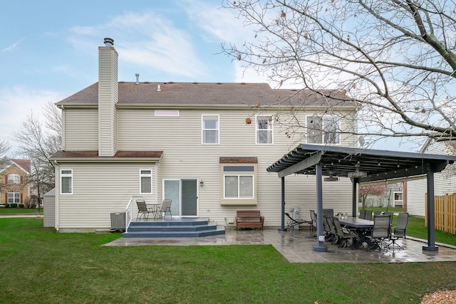 back of house with a chimney, a lawn, a patio area, and a pergola