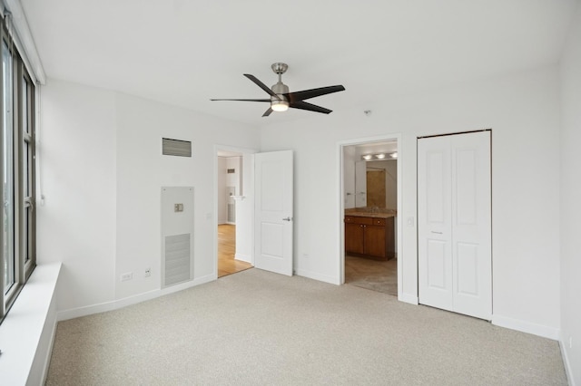 unfurnished bedroom featuring carpet, visible vents, and baseboards