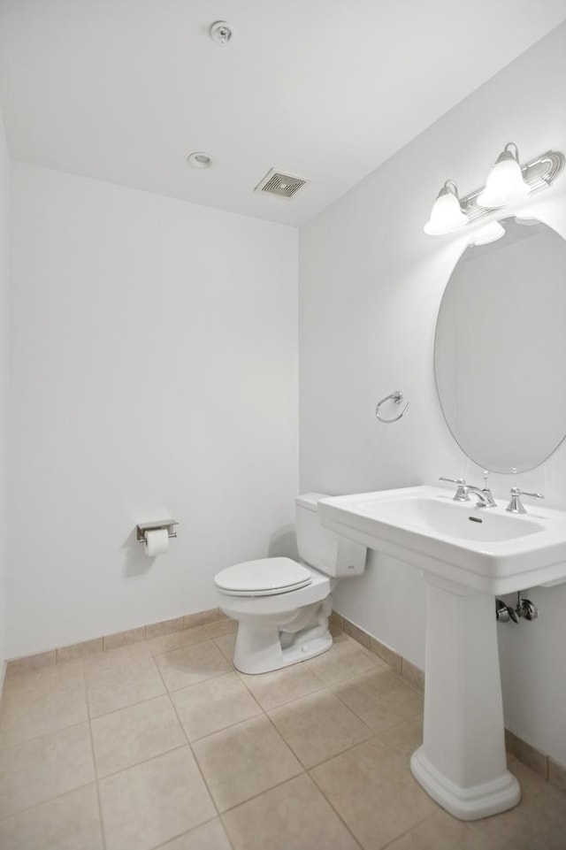 bathroom featuring tile patterned flooring, baseboards, visible vents, and toilet