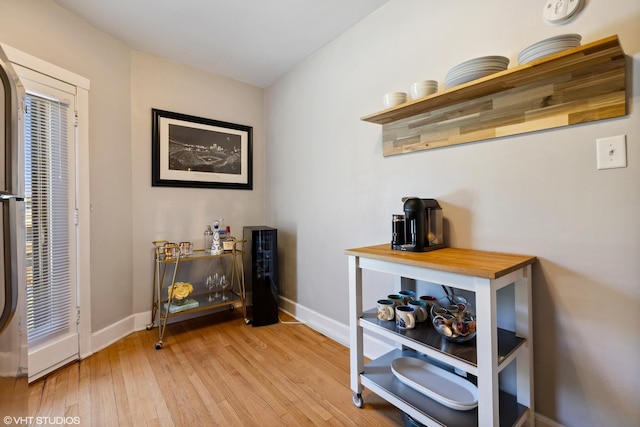 interior space featuring light wood-style flooring and baseboards