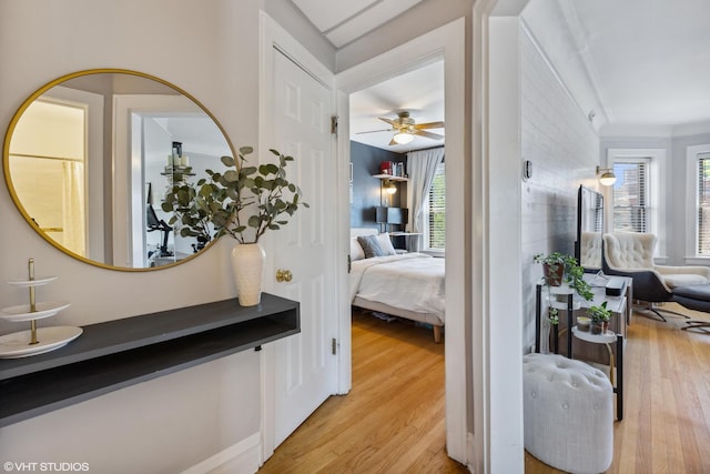 interior space with light wood finished floors and ornamental molding