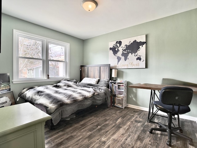 bedroom featuring dark wood-style floors and baseboards