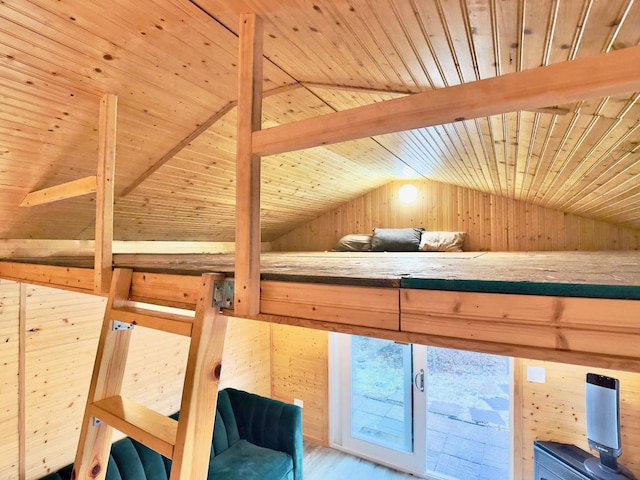 interior space with lofted ceiling with beams, wood walls, wooden ceiling, and wood finished floors