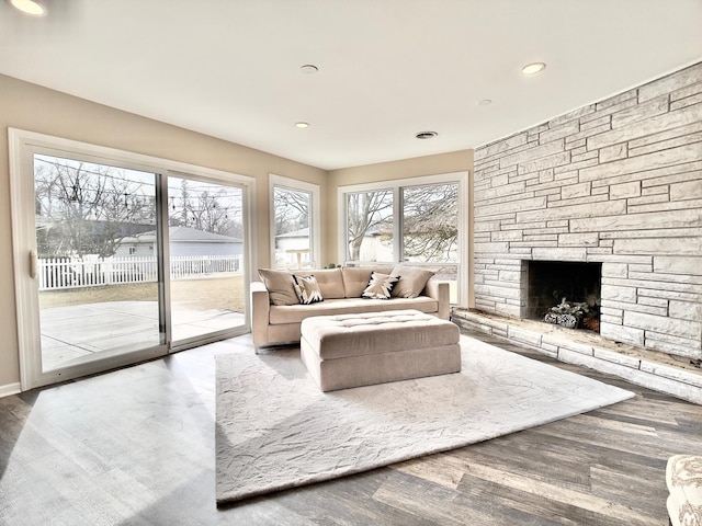 unfurnished living room with a fireplace, wood finished floors, and recessed lighting