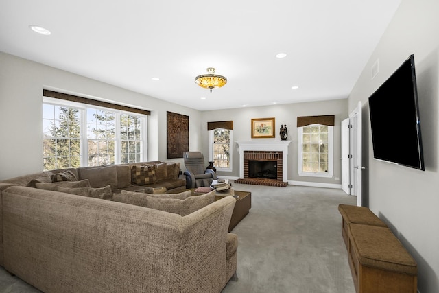 living room with recessed lighting, a brick fireplace, light colored carpet, and baseboards