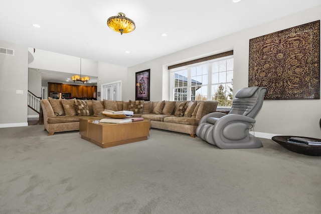 living area with a chandelier, recessed lighting, light carpet, and stairs