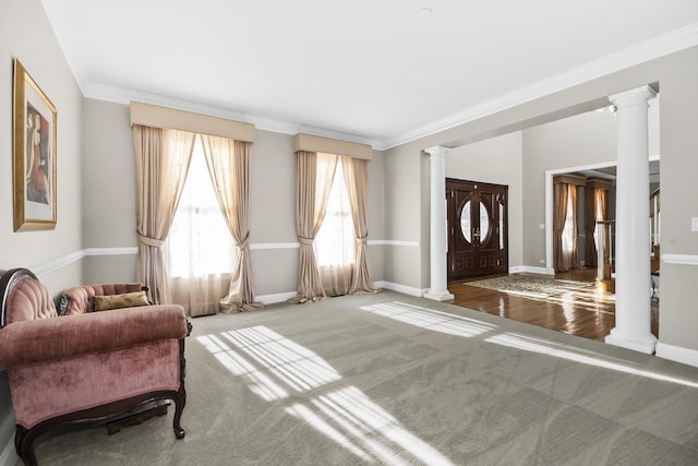 interior space featuring ornate columns, baseboards, and crown molding