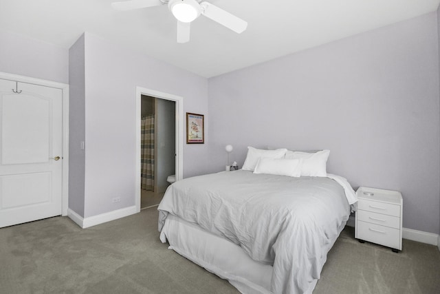 carpeted bedroom with ceiling fan, connected bathroom, and baseboards