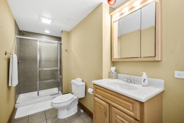 full bath with toilet, vanity, a shower stall, tile patterned flooring, and baseboards