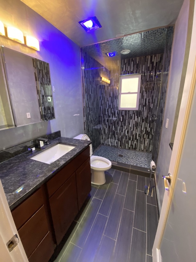 full bath with a shower stall, toilet, and vanity