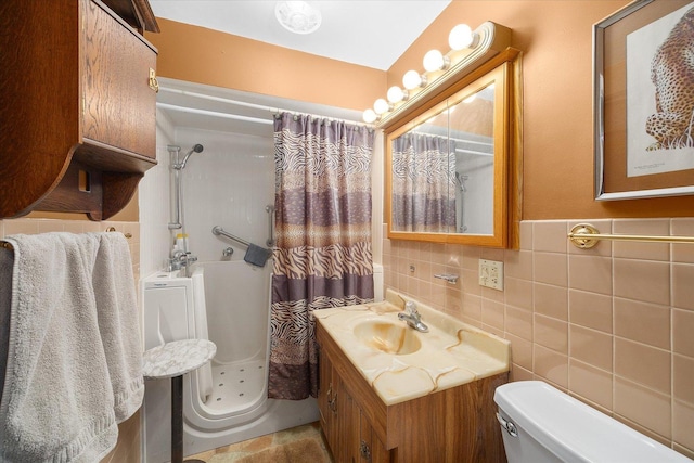 full bath with a shower with curtain, tile walls, vanity, and toilet