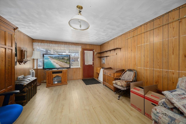 living area featuring wood finished floors and wood walls