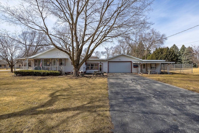 view of front of house with a porch, an attached garage, a front lawn, and driveway