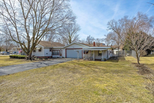 ranch-style house featuring aphalt driveway, an attached garage, a front yard, and fence