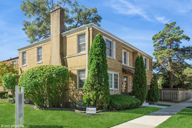 view of property exterior with a yard, brick siding, a chimney, and fence