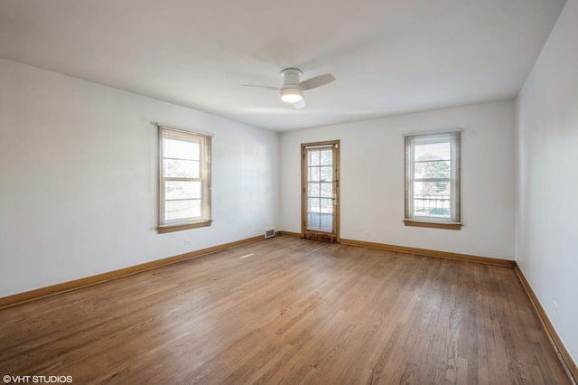 unfurnished room featuring light wood-style floors, ceiling fan, and baseboards