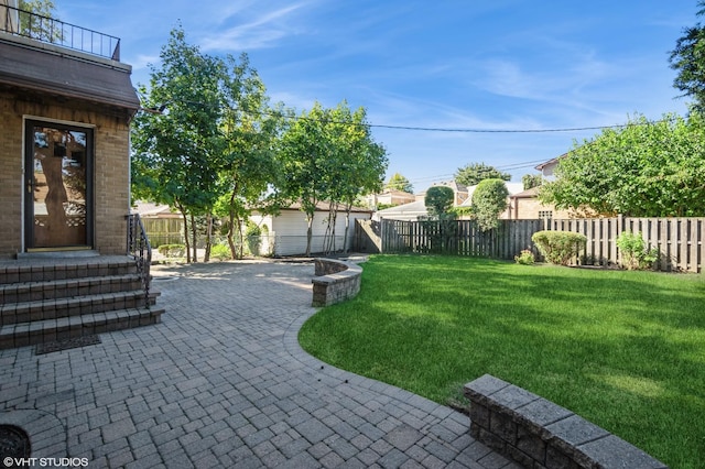 view of yard featuring entry steps, a patio area, and a fenced backyard