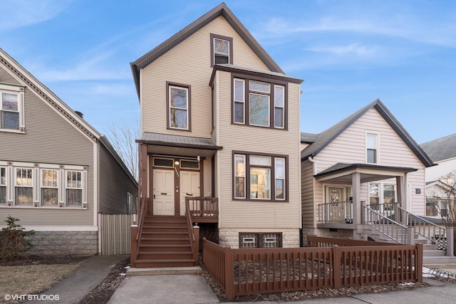 view of front of house with stairs and a fenced front yard