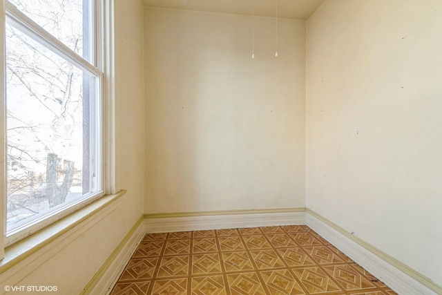 empty room featuring baseboards