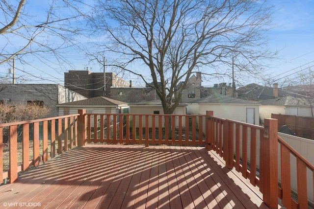 deck featuring an outbuilding and a storage unit