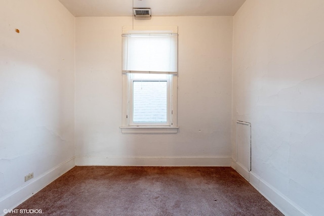 carpeted spare room featuring visible vents and baseboards