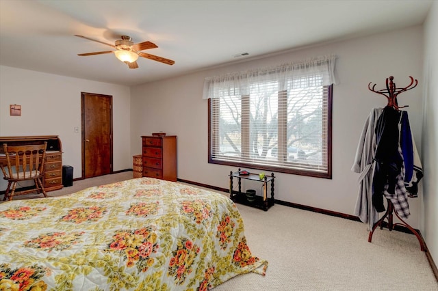 bedroom with ceiling fan, carpet floors, visible vents, and baseboards