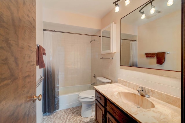 full bathroom featuring toilet, vanity, tile walls, and shower / bathtub combination with curtain