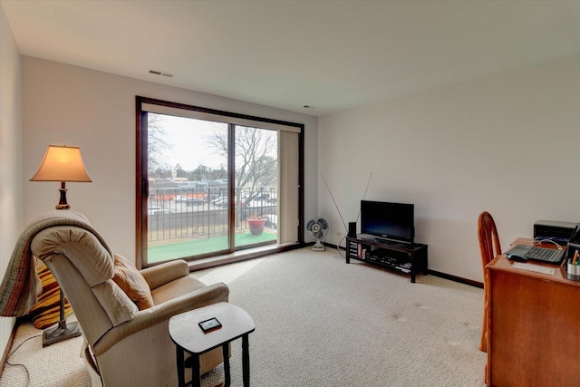 office with baseboards, visible vents, and light colored carpet