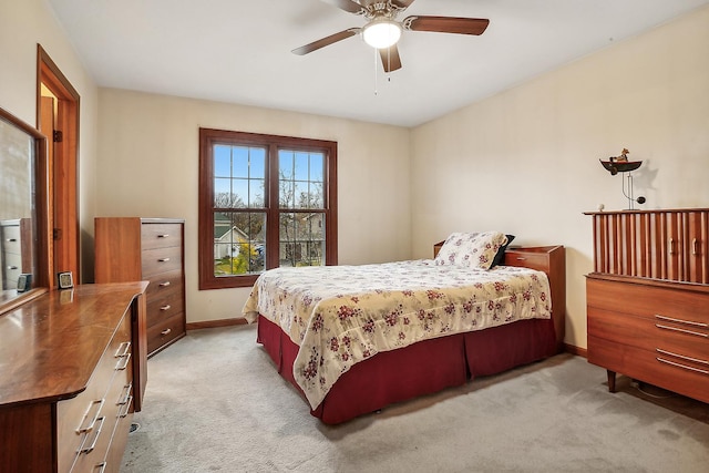 bedroom with baseboards, a ceiling fan, and light colored carpet