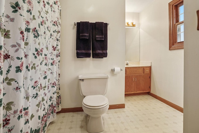 full bathroom with baseboards, vanity, toilet, and tile patterned floors
