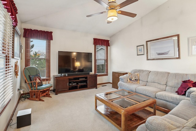 living room featuring lofted ceiling, ceiling fan, baseboards, and light colored carpet