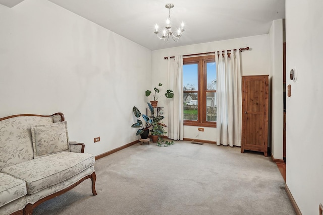 living area with an inviting chandelier, visible vents, baseboards, and carpet flooring