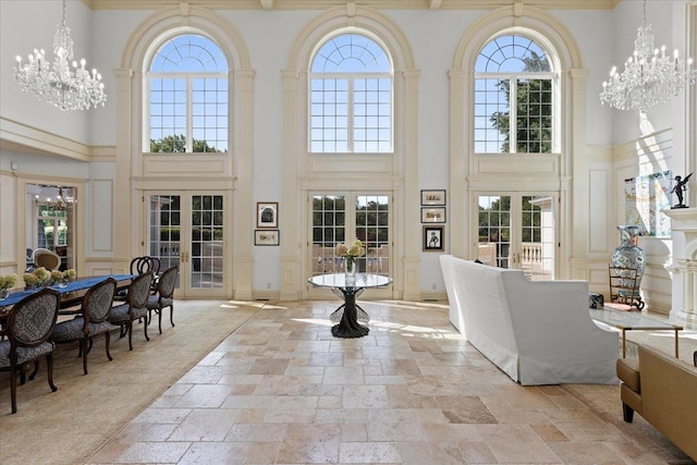 interior space with a chandelier, french doors, and a healthy amount of sunlight