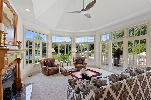 sunroom with visible vents, a ceiling fan, and a high end fireplace