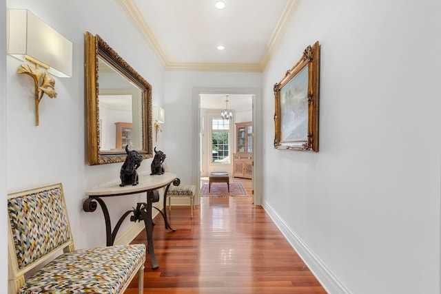 hallway with crown molding, baseboards, wood finished floors, and recessed lighting