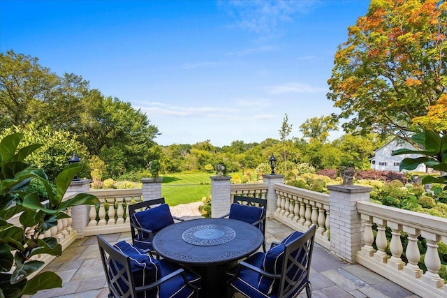 wooden deck with outdoor dining area and a patio area