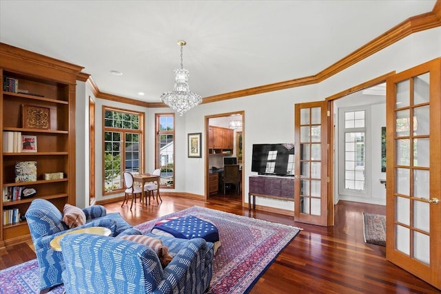 living area featuring ornamental molding, french doors, wood finished floors, and a notable chandelier