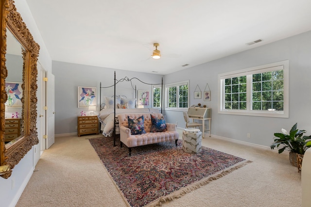 bedroom featuring baseboards, visible vents, and light colored carpet