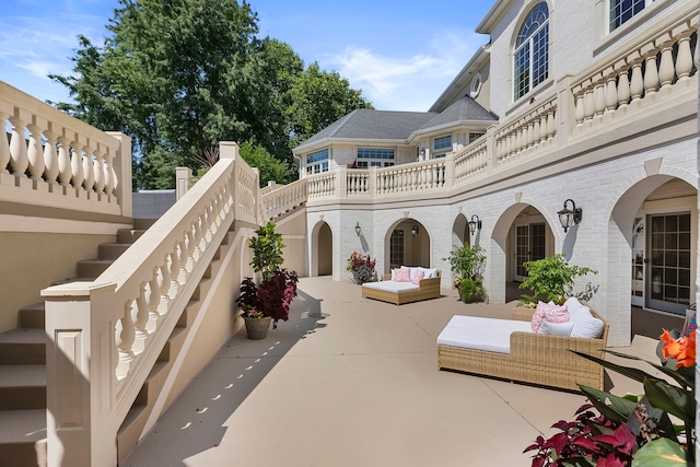 exterior space with stairs and an outdoor living space