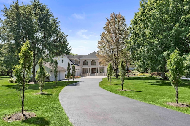 view of front of home with a front yard and driveway