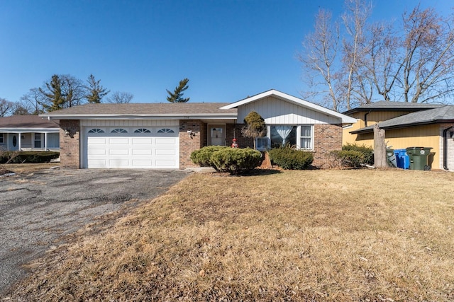 ranch-style house with a garage, driveway, and brick siding