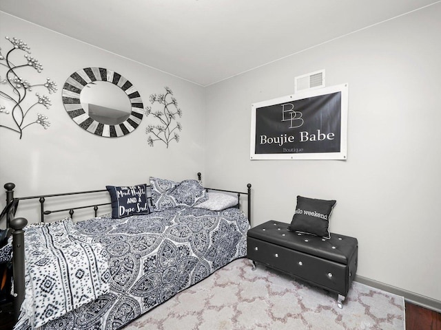 bedroom featuring visible vents and baseboards