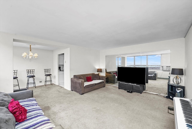 living area with an inviting chandelier and carpet floors