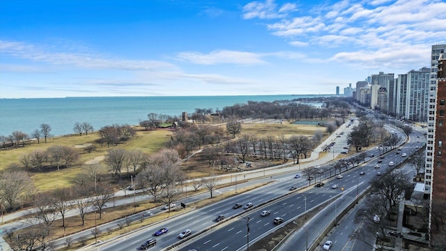 drone / aerial view featuring a water view and a view of city