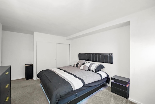 bedroom featuring carpet, a closet, and baseboards